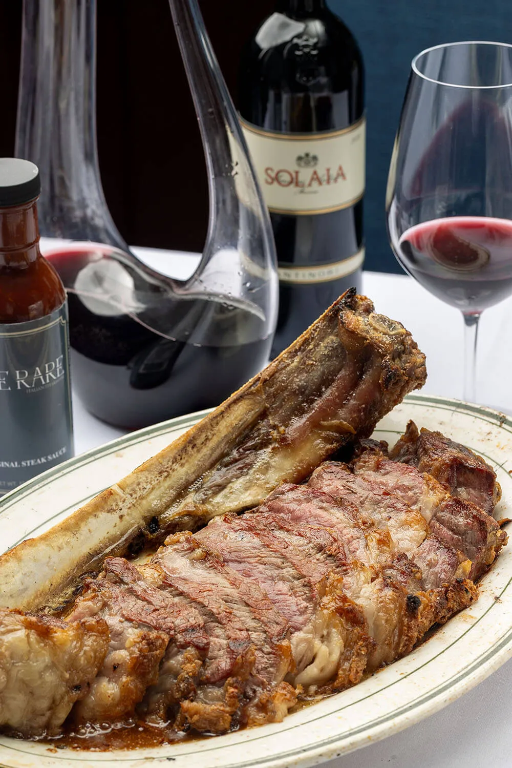 steak sauce, steak, wine and wine bottles